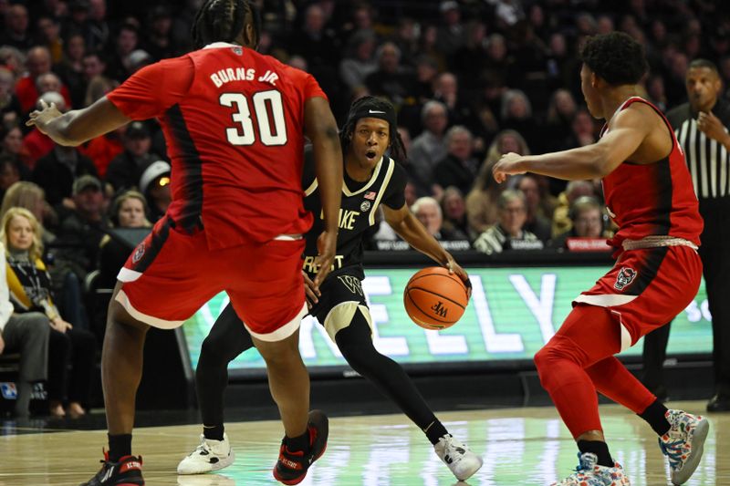 Jan 28, 2023; Winston-Salem, North Carolina, USA;   Wake Forest Demon Deacons guard Tyree Appleby (1) makes a move against North Carolina State Wolfpack forward D.J. Burns Jr. (30) during the first half at Lawrence Joel Veterans Memorial Coliseum. Mandatory Credit: William Howard-USA TODAY Sports