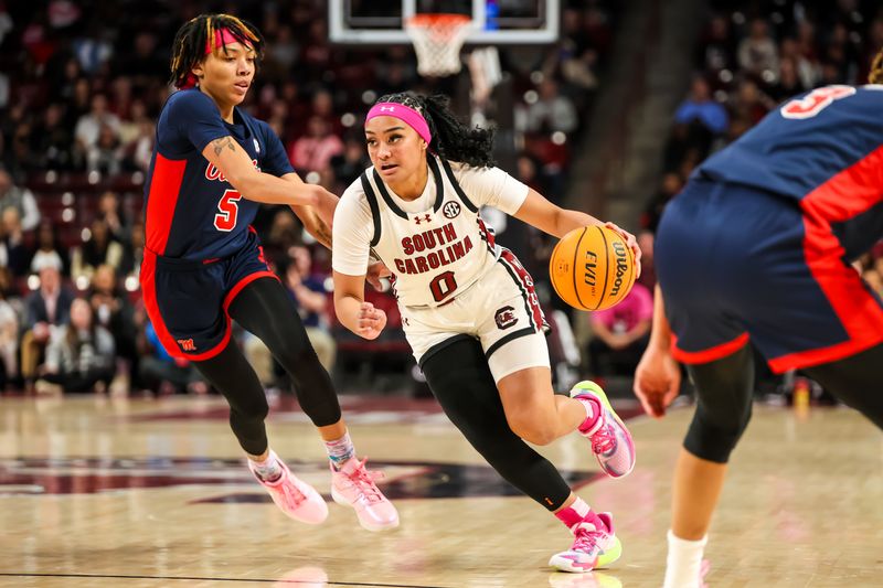 Feb 4, 2024; Columbia, South Carolina, USA; South Carolina Gamecocks guard Te-Hina Paopao (0) drives around Ole Miss Rebels forward Snudda Collins (5) in the first half at Colonial Life Arena. Mandatory Credit: Jeff Blake-USA TODAY Sports