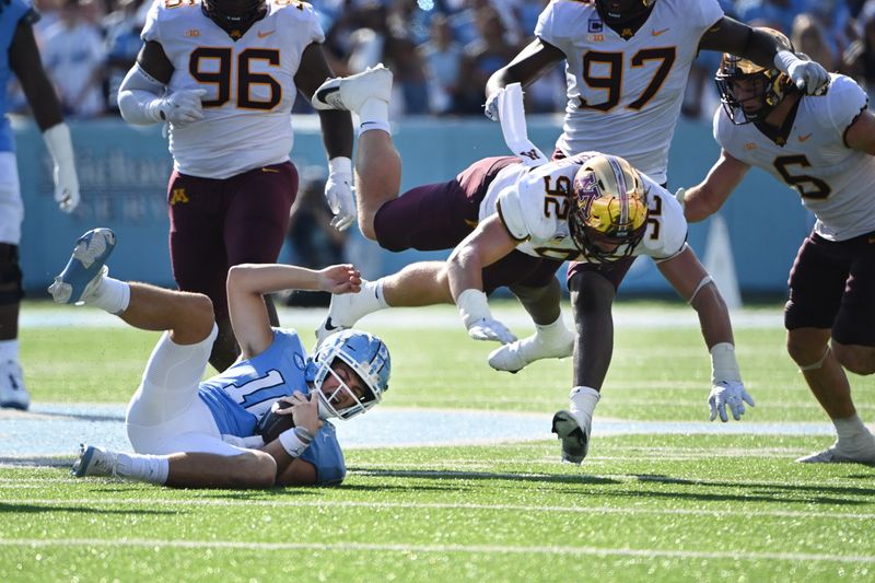 Sep 16, 2023; Chapel Hill, North Carolina, USA; North Carolina Tar Heels quarterback Drake Maye (10) slides as Minnesota Golden Gophers defensive lineman Danny Striggow (92) defends in the second quarter at Kenan Memorial Stadium. Mandatory Credit: Bob Donnan-USA TODAY Sports