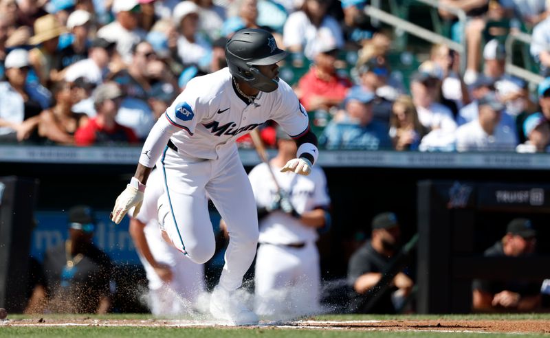 Feb 25, 2024; Jupiter, Florida, USA; Miami Marlins center fielder Jazz Chisholm Jr. (2) singles against the Washington Nationals in the second inning at Roger Dean Chevrolet Stadium. Mandatory Credit: Rhona Wise-USA TODAY Sports