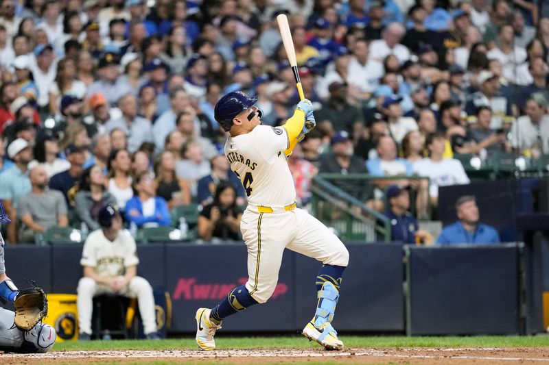 Aug 13, 2024; Milwaukee, Wisconsin, USA;  Milwaukee Brewers catcher William Contreras (24) hits a home run during the third inning against the Los Angeles Dodgers at American Family Field. Mandatory Credit: Jeff Hanisch-USA TODAY Sports