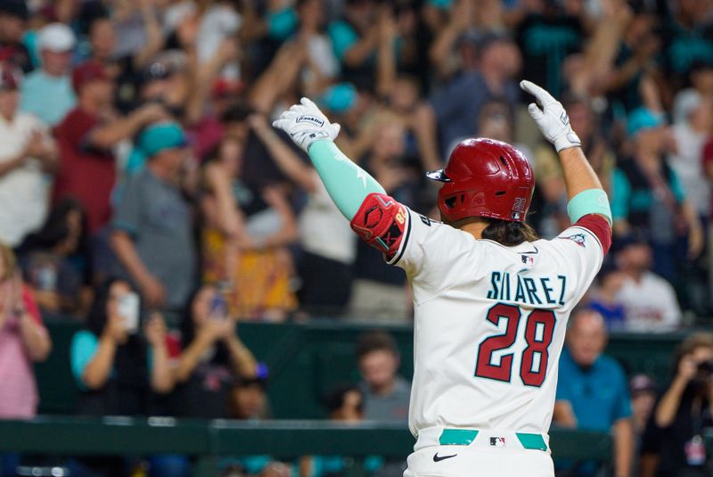 Apr 26, 2025; Phoenix, Arizona, USA;  Arizona Diamondbacks infielder Eugenio Suarez (28) reacts after hitting his fourth home run of the game against the Atlanta Braves during the ninth inning at Chase Field. Mandatory Credit: Allan Henry-Imagn Images