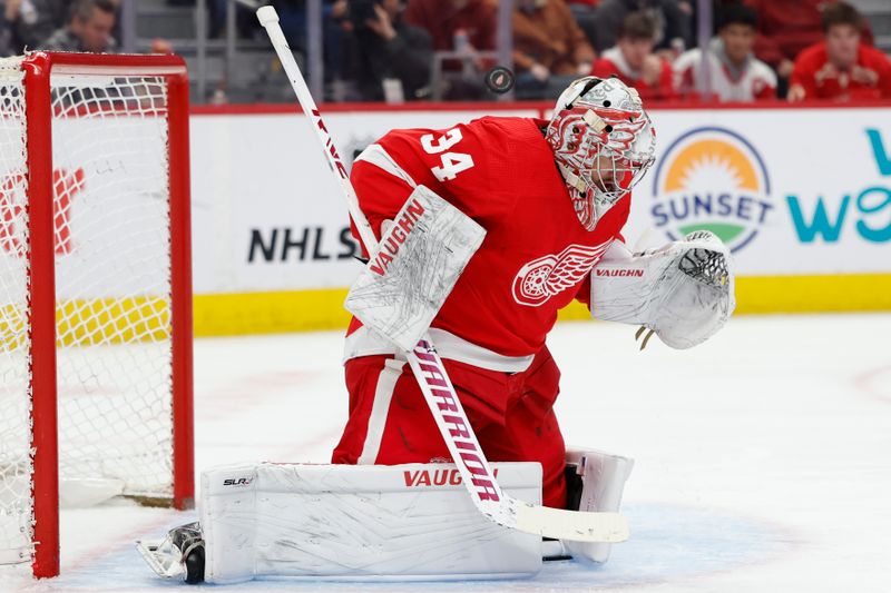 Feb 22, 2024; Detroit, Michigan, USA; Detroit Red Wings goaltender Alex Lyon (34) makes a save in the first period against the Colorado Avalanche at Little Caesars Arena. Mandatory Credit: Rick Osentoski-USA TODAY Sports