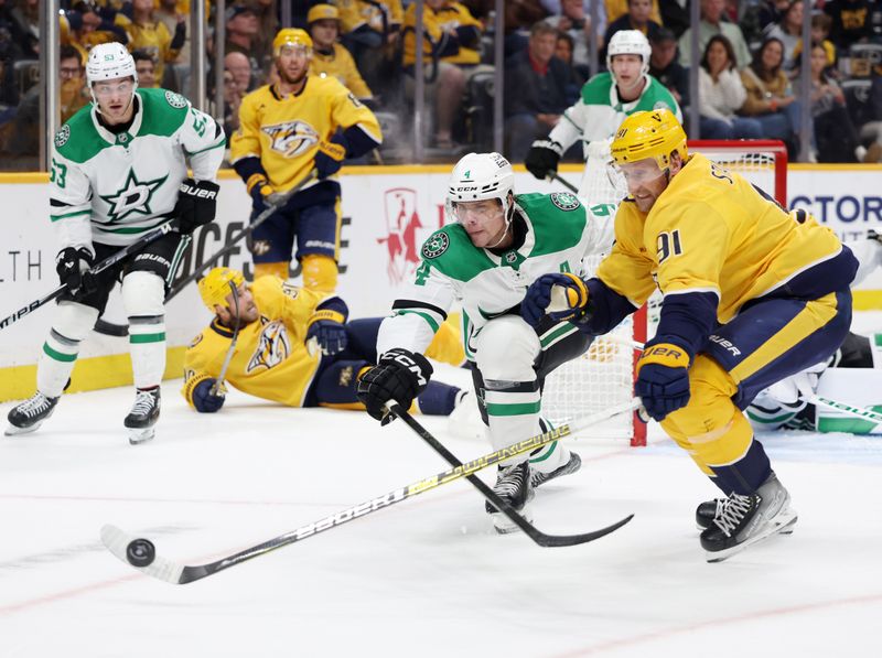 Nov 8, 2025; Nashville, Tennessee, USA; Dallas Stars defenseman Miro Heiskanen (4) competes for the puck with Nashville Predators center Steven Stamkos (91) during the third period at Bridgestone Arena. Mandatory Credit: Alan Poizner-Imagn Images