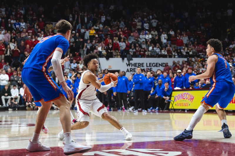 Mar 5, 2025; Tuscaloosa, Alabama, USA; Alabama Crimson Tide guard Mark Sears (1) drives the ball against Florida Gators guard Walter Clayton Jr. (1) and forward Alex Condon (21) during the second half at Coleman Coliseum. Mandatory Credit: Will McLelland-Imagn Images