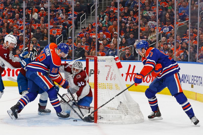 Mar 16, 2024; Edmonton, Alberta, CAN; Edmonton Oilers forward Connor McDavid (97) and forward Zach Hyman (18) try to jam a loose puck past Colorado Avalanche goaltender Alexander Georgiev (40) during the first period at Rogers Place. Mandatory Credit: Perry Nelson-USA TODAY Sports