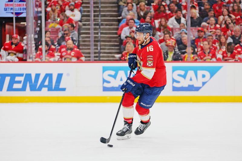 May 26, 2025; Sunrise, Florida, USA; Florida Panthers center Aleksander Barkov (16) controls the puck during the first period against the Carolina Hurricanes in game four of the Eastern Conference Final of the 2025 Stanley Cup Playoffs at Amerant Bank Arena. Mandatory Credit: Sam Navarro-Imagn Images