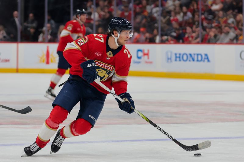 Nov 25, 2024; Sunrise, Florida, USA; Florida Panthers center Eetu Luostarinen (27) moves the puck against the Washington Capitals during the second period at Amerant Bank Arena. Mandatory Credit: Sam Navarro-Imagn Images