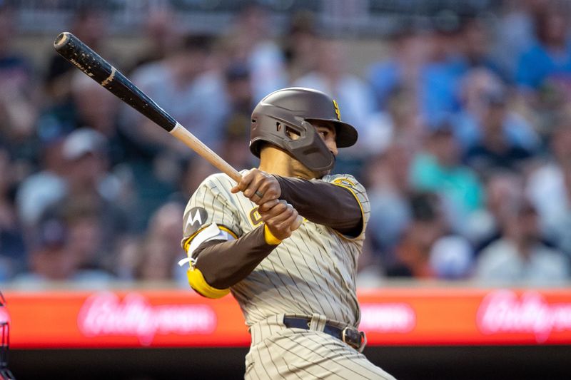 May 10, 2023; Minneapolis, Minnesota, USA; San Diego Padres center fielder Trent Grisham (1) hits a single in the eighth inning against the Minnesota Twins at Target Field. Mandatory Credit: Jesse Johnson-USA TODAY Sports