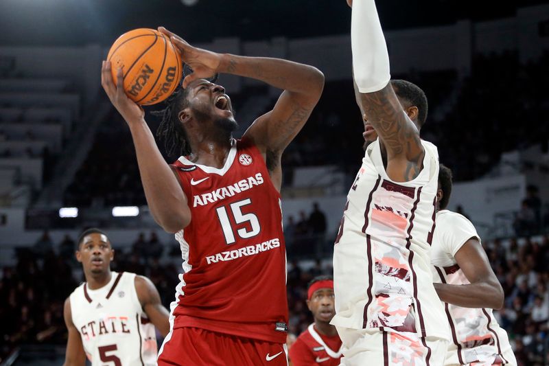 Feb 17, 2024; Starkville, Mississippi, USA; Arkansas Razorbacks forward Makhi Mitchell (15) drives to the basket against Mississippi State Bulldogs forward Jimmy Bell Jr. (15) during the second half at Humphrey Coliseum. Mandatory Credit: Petre Thomas-USA TODAY Sports