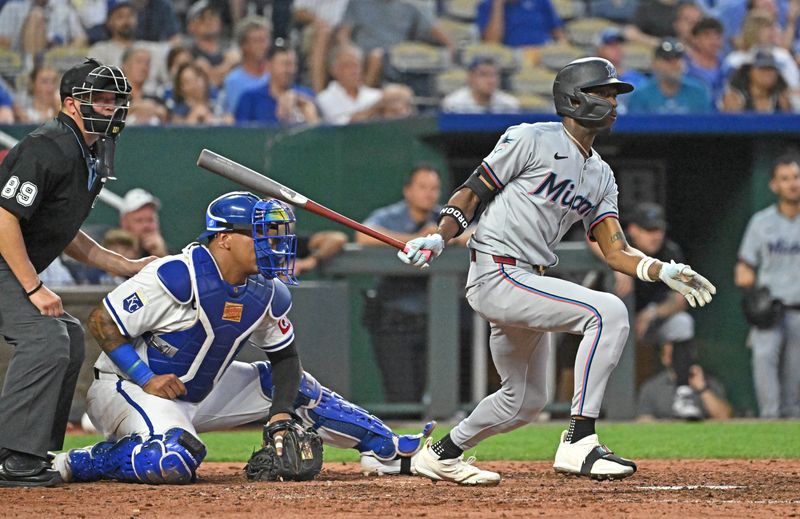 Jun 25, 2024; Kansas City, Missouri, USA; Miami Marlins left fielder Nick Gordon (1) hits an RBI single in the seventh inning against the Kansas City Royals at Kauffman Stadium. Mandatory Credit: Peter Aiken-USA TODAY Sports