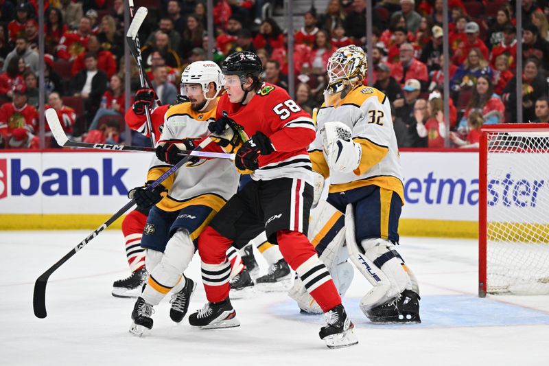 Apr 12, 2024; Chicago, Illinois, USA; Nashville Predators defenseman Alexandre Carrier (45) and Chicago Blackhawks forward MacKenzie Entwistle (58) battle for position in front of goaltender Kevin Lankinen (32) in the second period at United Center. Mandatory Credit: Jamie Sabau-USA TODAY Sports