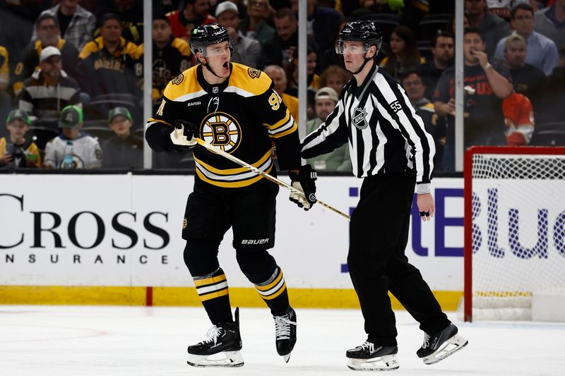 Mar 11, 2025; Boston, Massachusetts, USA; Boston Bruins defenseman Nikita Zadorov (91) is escorted to the penalty box after being called for a penalty during the third period against the Florida Panthers at TD Garden. Mandatory Credit: Winslow Townson-Imagn Images