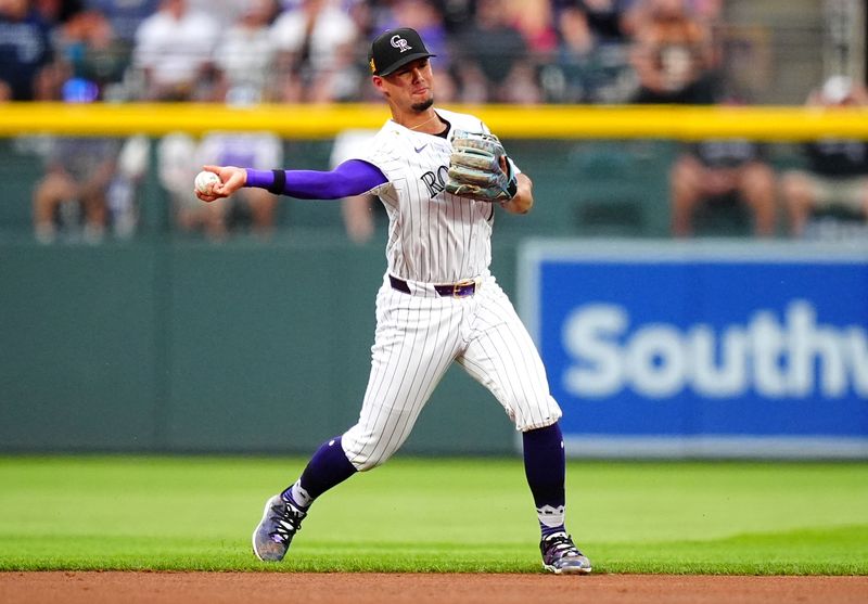 Aug 17, 2024; Denver, Colorado, USA; Colorado Rockies shortstop Ezequiel Tovar (14) fields the ball in the first inning against the San Diego Padres at Coors Field. Mandatory Credit: Ron Chenoy-USA TODAY Sports