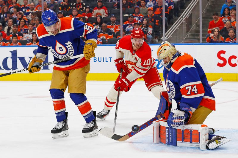 Feb 24, 2024; Edmonton, Alberta, CAN; Edmonton Oilers goaltender Stuart Skinner (74) makes a save on a deflection by Calgary Flames forward Jonathan Huberdeau (10) during the second period at Rogers Place. Mandatory Credit: Perry Nelson-USA TODAY Sports