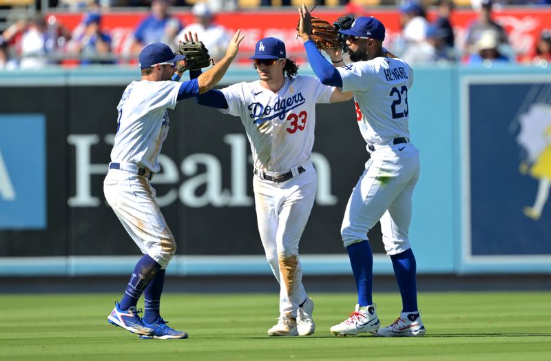 Sep 3, 2023; Los Angeles, California, USA; Los Angeles Dodgers left fielder Chris Taylor (3) and center fielder James Outman (33) and right fielder Jason Heyward (23) celebrate after the final out of the ninth inning against the Atlanta Braves at Dodger Stadium. Mandatory Credit: Jayne Kamin-Oncea-USA TODAY Sports