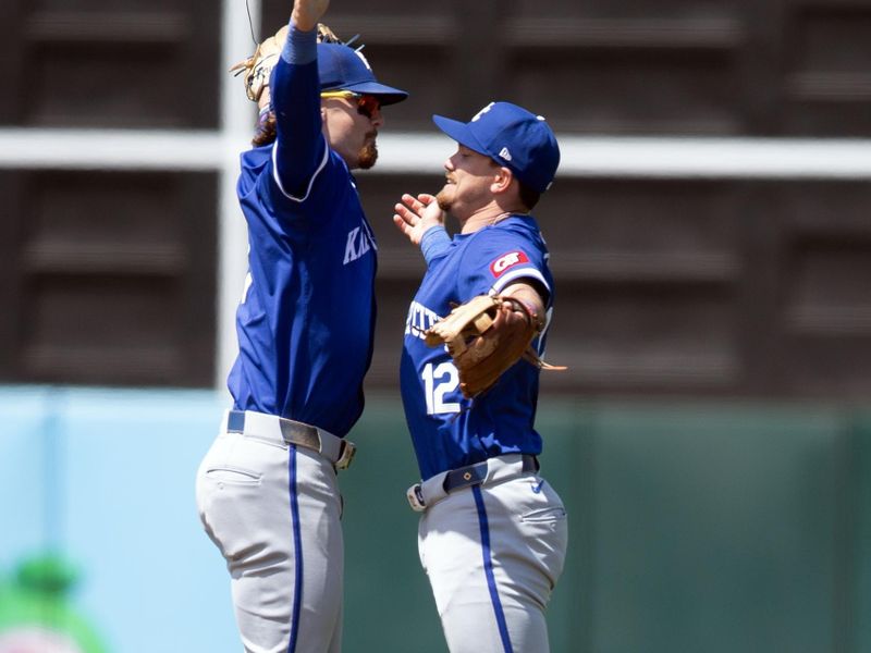 Jun 20, 2024; Oakland, California, USA; Kansas City Royals shortstop Bobby Witt Jr. (left) and third baseman Nick Loftin (12) celebrate a 3-2 victory over the Oakland Athletics at Oakland-Alameda County Coliseum. Mandatory Credit: D. Ross Cameron-USA TODAY Sports