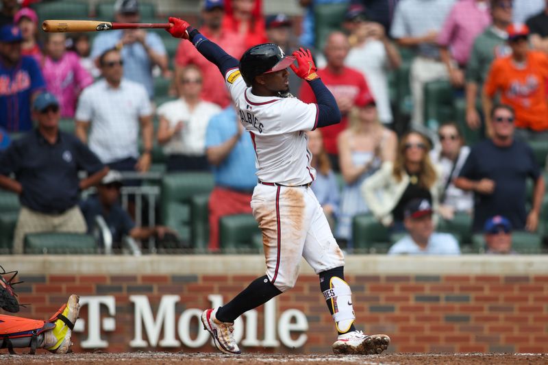Sep 30, 2024; Atlanta, Georgia, USA; Atlanta Braves second baseman Ozzie Albies (1) hits a three-run double against the New York Mets in the eighth inning at Truist Park. Mandatory Credit: Brett Davis-Imagn Images
