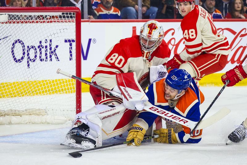 Jan 20, 2024; Calgary, Alberta, CAN; Calgary Flames goaltender Dan Vladar (80) and Edmonton Oilers center Derek Ryan (10) collides during the first period at Scotiabank Saddledome. Mandatory Credit: Sergei Belski-USA TODAY Sports