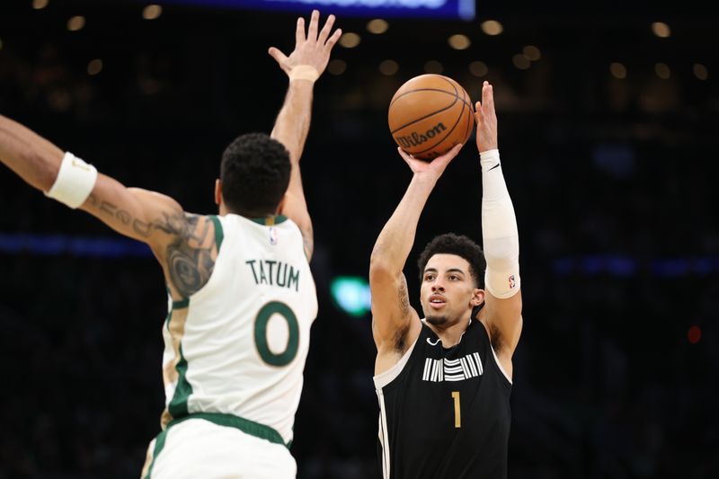 BOSTON, MASSACHUSETTS - FEBRUARY 04: Scotty Pippen Jr #1 of the Memphis Grizzlies shoots the ball against Jayson Tatum #0 of the Boston Celtics during the second half at TD Garden on February 04, 2024 in Boston, Massachusetts. NOTE TO USER: User expressly acknowledges and agrees that, by downloading and or using this photograph, User is consenting to the terms and conditions of the Getty Images License Agreement. (Photo by Paul Rutherford/Getty Images)