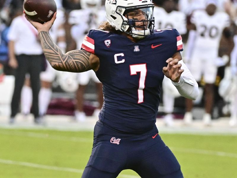 Sep 9, 2023; Starkville, Mississippi, USA; Arizona Wildcats quarterback Jayden de Laura (7) looks to pass against the Mississippi State Bulldogs during the first quarter at Davis Wade Stadium at Scott Field. Mandatory Credit: Matt Bush-USA TODAY Sports