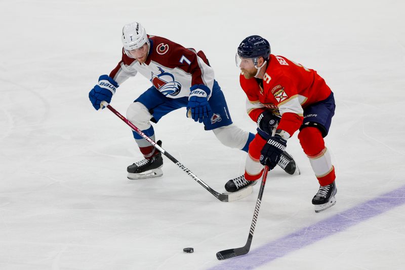 Feb 11, 2023; Sunrise, Florida, USA; Florida Panthers center Sam Bennett (9) protects the puck from Colorado Avalanche defenseman Devon Toews (7) during the third period at FLA Live Arena. Mandatory Credit: Sam Navarro-USA TODAY Sports