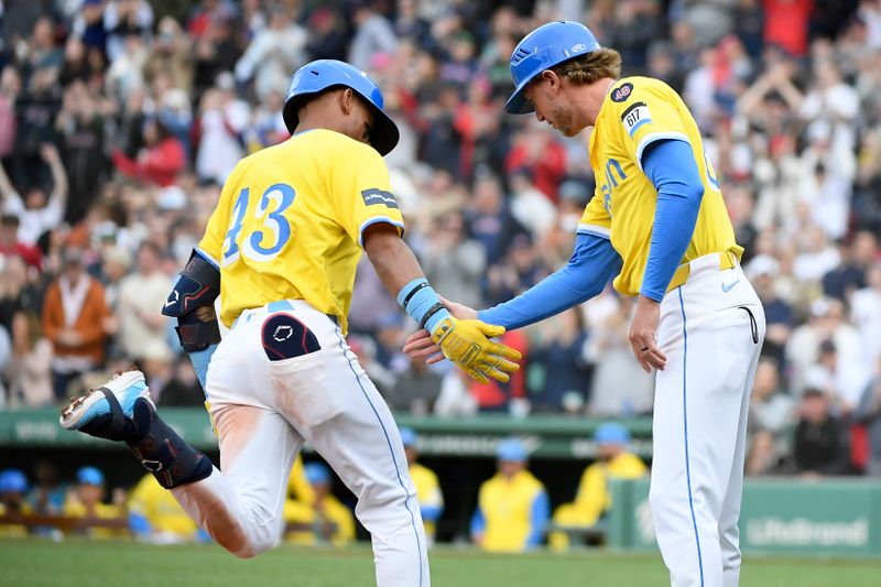 Apr 27, 2024; Boston, Massachusetts, USA;  Boston Red Sox short stop Ceddanne Rafaela (43) is congratulated by third base coach Kyle Hudson (84) after hitting a two run home run during the seventh inning against the Chicago Cubs at Fenway Park. Mandatory Credit: Bob DeChiara-USA TODAY Sports