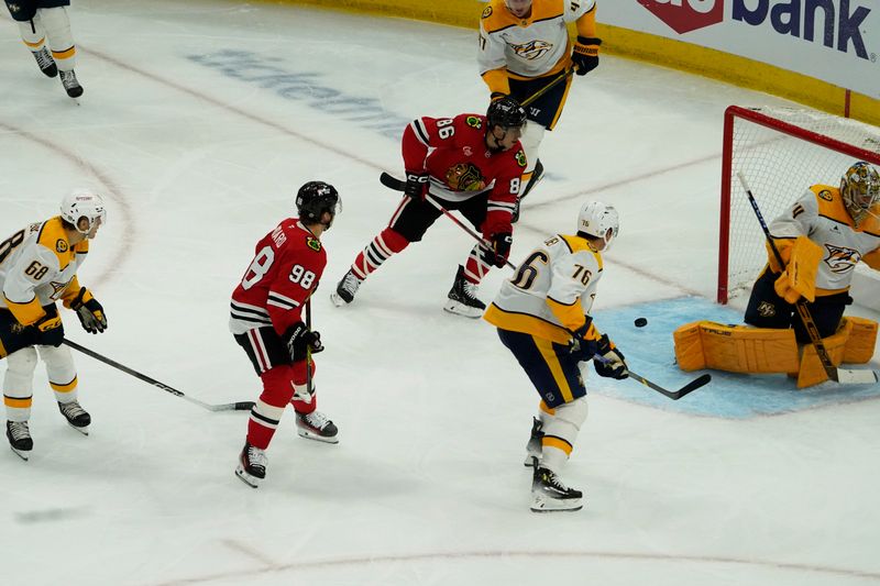 Oct 25, 2024; Chicago, Illinois, USA; Chicago Blackhawks center Connor Bedard (98) scores a goal on Nashville Predators goaltender Juuse Saros (74) during the second period at the United Center. Mandatory Credit: David Banks-Imagn Images