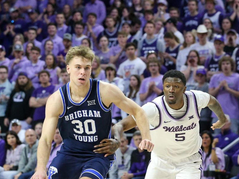 Feb 24, 2024; Manhattan, Kansas, USA; Brigham Young Cougars guard Dallin Hall (30) dribbles bypass Kansas State Wildcats guard Cam Carter (5) during the second half at Bramlage Coliseum. Mandatory Credit: Scott Sewell-USA TODAY Sports