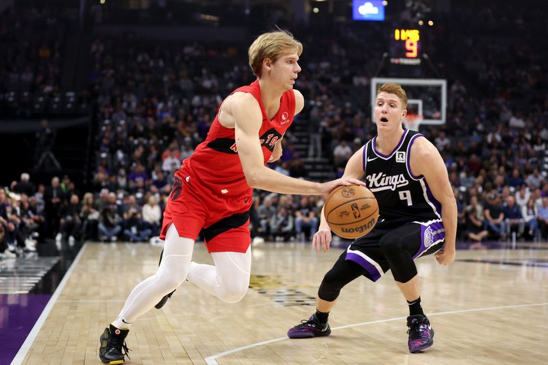 SACRAMENTO, CALIFORNIA - NOVEMBER 06: Gradey Dick #1 of the Toronto Raptors is guarded by Kevin Huerter #9 of the Sacramento Kings in the first half at Golden 1 Center on November 06, 2024 in Sacramento, California. NOTE TO USER: User expressly acknowledges and agrees that, by downloading and/or using this photograph, user is consenting to the terms and conditions of the Getty Images License Agreement.  (Photo by Ezra Shaw/Getty Images)