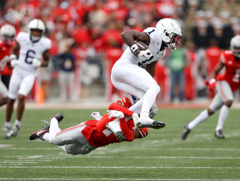 Oct 21, 2023; Columbus, Ohio, USA; Ohio State Buckeyes cornerback Jordan Hancock (7) tackles Penn State Nittany Lions wide receiver KeAndre Lambert-Smith (1) during the fourth quarter at Ohio Stadium. Mandatory Credit: Joseph Maiorana-USA TODAY Sports