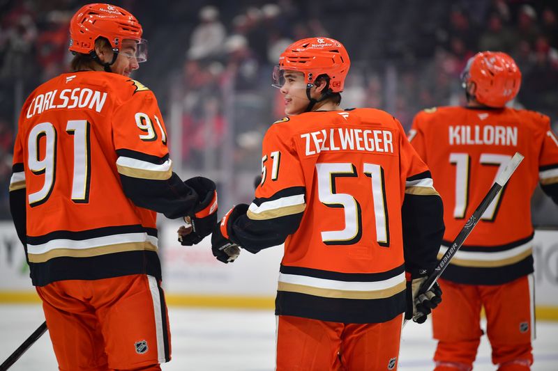 Nov 15, 2024; Anaheim, California, USA; Anaheim Ducks defenseman Olen Zellweger (51) celebrates his goal scored against the Detroit Red Wings with center Leo Carlsson (91) during the first period at Honda Center. Carlsson provided an assist on the goal.  Mandatory Credit: Gary A. Vasquez-Imagn Images