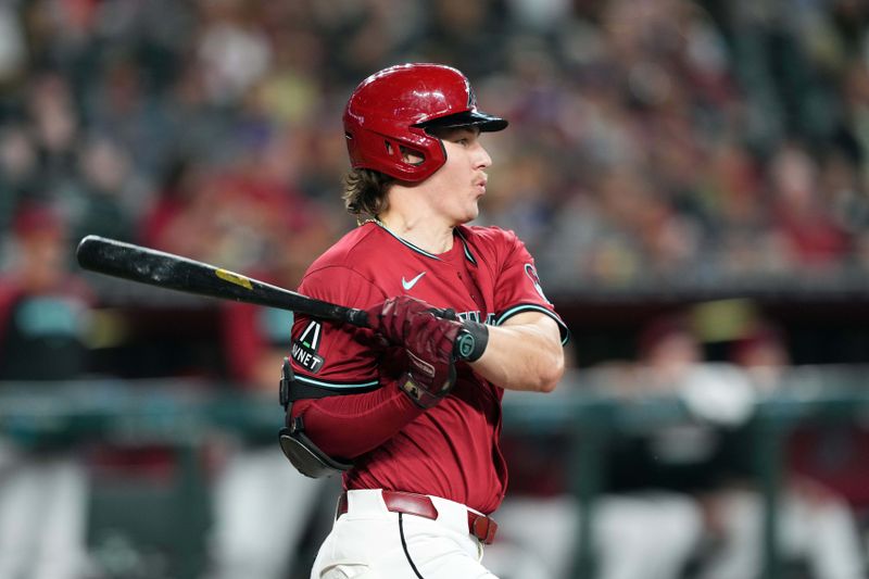 May 5, 2024; Phoenix, Arizona, USA; Arizona Diamondbacks outfielder Jake McCarthy (31) hits a single against the San Diego Padres during the first inning at Chase Field. Mandatory Credit: Joe Camporeale-USA TODAY Sports