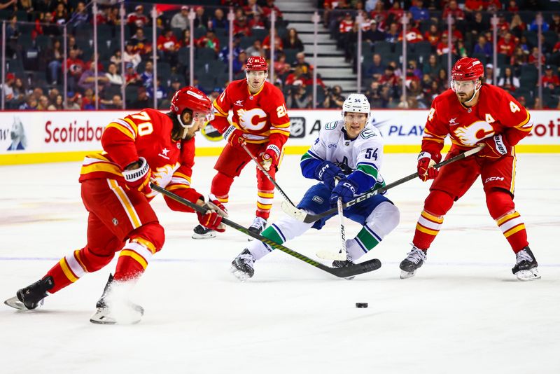 Sep 28, 2024; Calgary, Alberta, CAN; Vancouver Canucks center Aatu Raty (54) controls the puck against the Calgary Flames during the first period at Scotiabank Saddledome. Mandatory Credit: Sergei Belski-Imagn Images