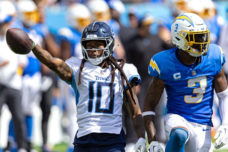 Tennessee Titans wide receiver DeAndre Hopkins (10) reacts to making a first down after being tackled by Los Angeles Chargers safety Derwin James Jr. (3) during their NFL football game Sunday, Sept. 17, 2023, in Nashville, Tenn. (AP Photo/Wade Payne)