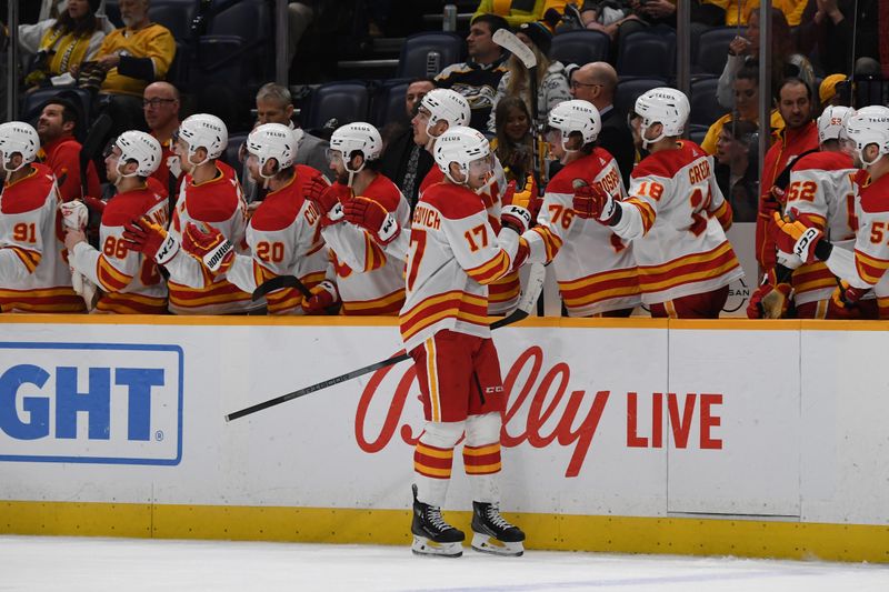 Jan 4, 2024; Nashville, Tennessee, USA; Calgary Flames center Yegor Sharangovich (17) celebrates after a goal during the third period against the Nashville Predators at Bridgestone Arena. Mandatory Credit: Christopher Hanewinckel-USA TODAY Sports