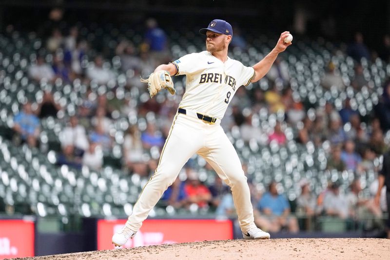 Jul 9, 2024; Milwaukee, Wisconsin, USA;  Milwaukee Brewers first baseman Jake Bauers (9) throws a pitch during the ninth inning against the Pittsburgh Pirates at American Family Field. Mandatory Credit: Jeff Hanisch-USA TODAY Sports