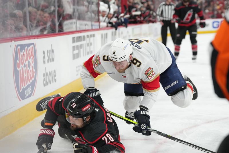 May 22, 2025; Raleigh, North Carolina, USA;  Florida Panthers forward Sam Bennett (9) battles for the puck against Carolina Hurricanes forward William Carrier (28) during the third period in game two of the Eastern Conference Final of the 2025 Stanley Cup Playoffs at Lenovo Center. Mandatory Credit: James Guillory-Imagn Images