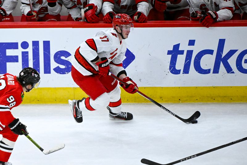 Jan 20, 2025; Chicago, Illinois, USA;  Carolina Hurricanes right wing Andrei Svechnikov (37) moves the puck against the Chicago Blackhawks during the third period at the United Center. Mandatory Credit: Matt Marton-Imagn Images