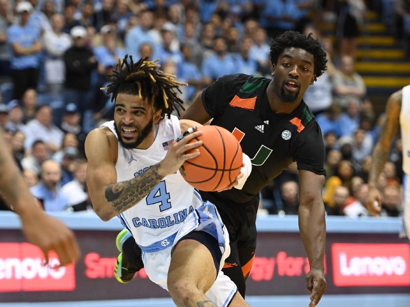 Feb 13, 2023; Chapel Hill, North Carolina, USA; North Carolina Tar Heels guard R.J. Davis (4) with the ball as Miami (Fl) Hurricanes guard Bensley Joseph (4) defends in the second half at Dean E. Smith Center. Mandatory Credit: Bob Donnan-USA TODAY Sports