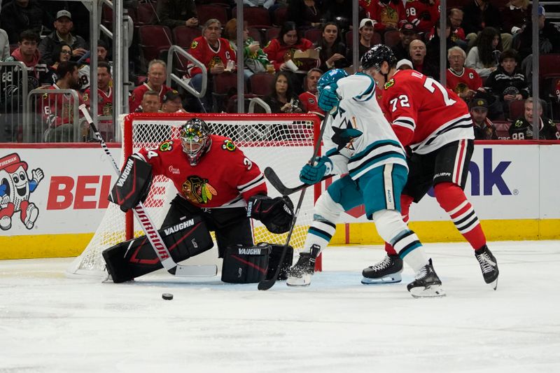 Oct 17, 2024; Chicago, Illinois, USA; San Jose Sharks center Luke Kunin (11) shoots the puck on Chicago Blackhawks goaltender Petr Mrazek (34) during the second period at United Center. Mandatory Credit: David Banks-Imagn Images