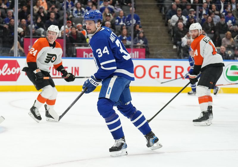 Feb 15, 2024; Toronto, Ontario, CAN; Toronto Maple Leafs center Auston Matthews (34) follows the play against the Philadelphia Flyers during the first period at Scotiabank Arena. Mandatory Credit: Nick Turchiaro-USA TODAY Sports