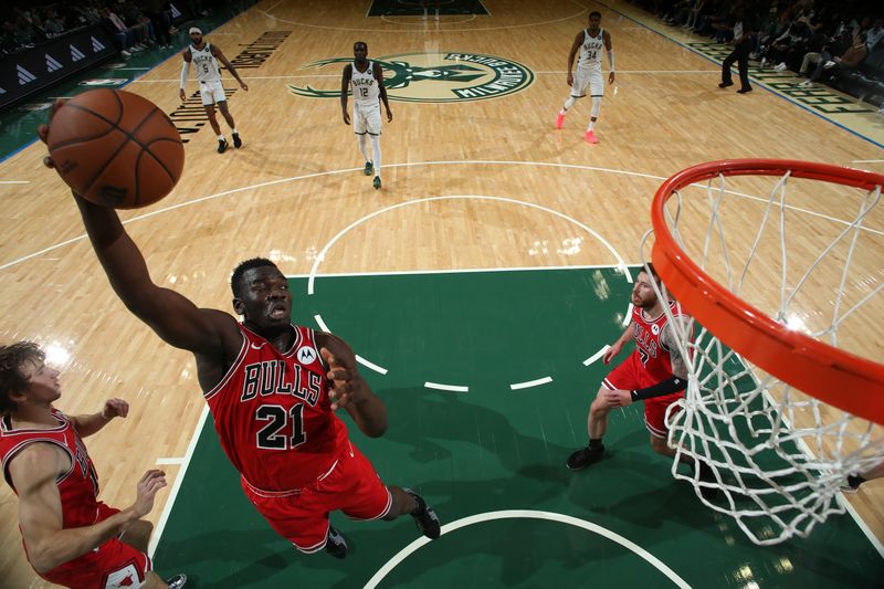 MILWAUKEE, WI - OCTOBER 14: Adama Sanogo #21 of the Chicago Bulls rebounds during the game against the Milwaukee Bucks on October 14, 2024 at Fiserv Forum Center in Milwaukee, Wisconsin. NOTE TO USER: User expressly acknowledges and agrees that, by downloading and or using this Photograph, user is consenting to the terms and conditions of the Getty Images License Agreement. Mandatory Copyright Notice: Copyright 2024 NBAE (Photo by Gary Dineen/NBAE via Getty Images).