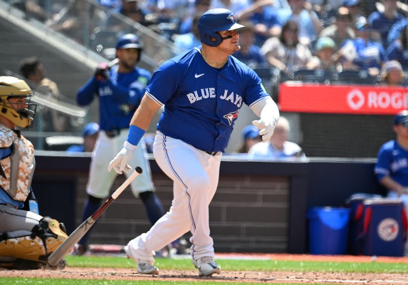 May 19, 2024; Toronto, Ontario, CAN; Toronto Blue Jays designated hitter Daniel Vogelbach (20) hits a single against the Tampa Bay Rays in the sixth inning at Rogers Centre. Mandatory Credit: Dan Hamilton-USA TODAY Sports