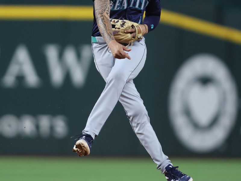 Sep 20, 2024; Arlington, Texas, USA; Seattle Mariners shortstop J.P. Crawford (3) throws to first against the Texas Rangers in the third inning at Globe Life Field. Mandatory Credit: Tim Heitman-Imagn Images