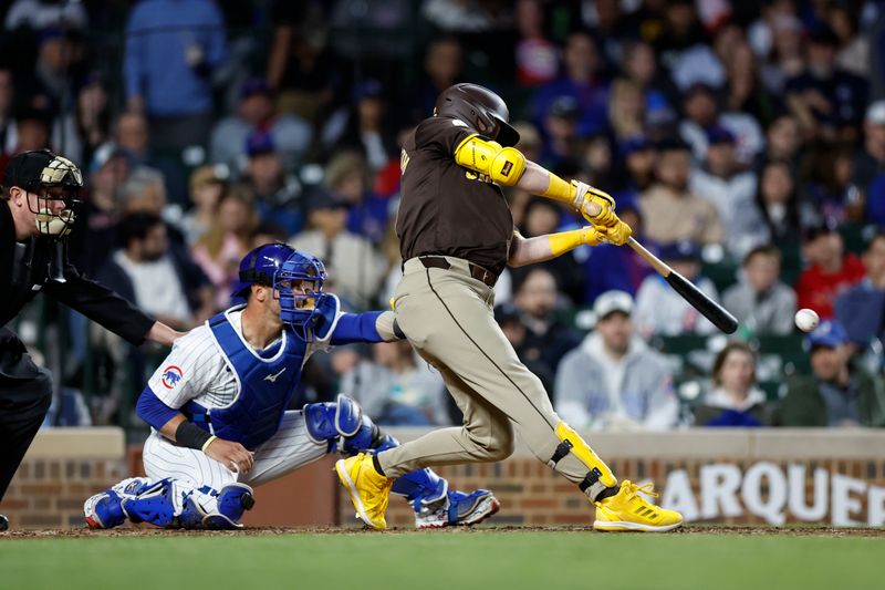 May 6, 2024; Chicago, Illinois, USA; San Diego Padres first baseman Jake Cronenworth (9) singles against the Chicago Cubs during the sixth inning at Wrigley Field. Mandatory Credit: Kamil Krzaczynski-USA TODAY Sports