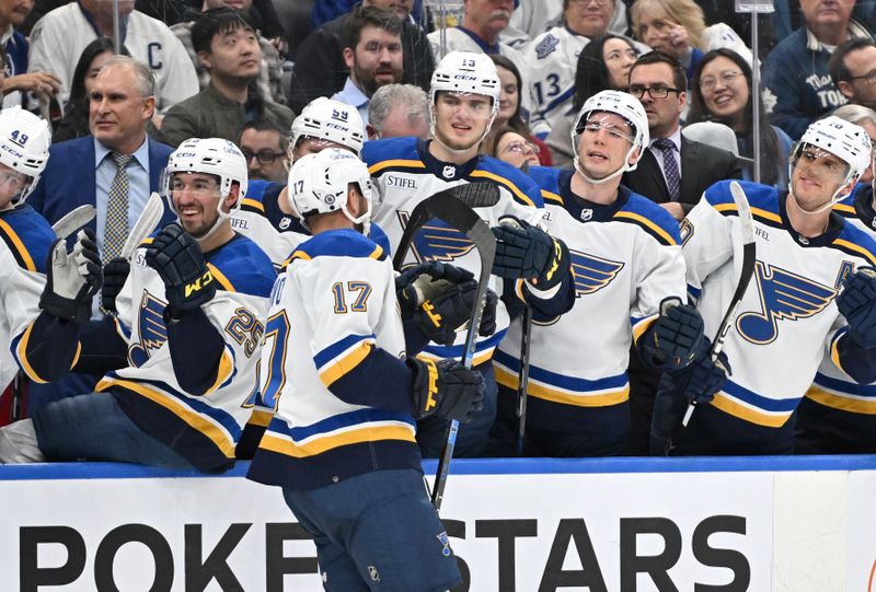 Jan 3, 2023; Toronto, Ontario, CAN; St. Louis Blues forward Josh Leivo (17) celebrates with teammates at the bench after scoring against the Toronto Maple Leafs in the second period at Scotiabank Arena. Mandatory Credit: Dan Hamilton-USA TODAY Sports