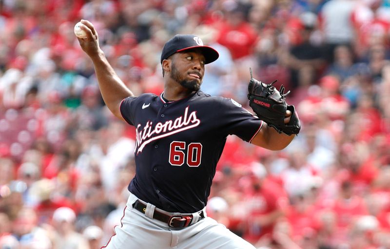 Aug 5, 2023; Cincinnati, Ohio, USA; Washington Nationals Joan Adon (60) throws against the Cincinnati Reds during the second inning at Great American Ball Park. Mandatory Credit: David Kohl-USA TODAY Sports