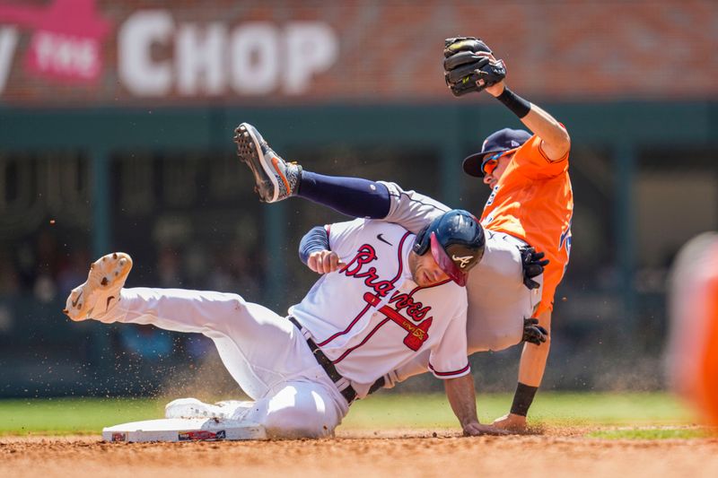 Apr 23, 2023; Cumberland, Georgia, USA; Atlanta Braves first baseman Matt Olson (28) takes out Houston Astros second baseman Mauricio Dubon (14) causing an error on a throw during the sixth inning at Truist Park. Mandatory Credit: Dale Zanine-USA TODAY Sports