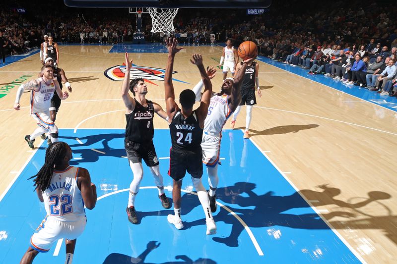 OKLAHOMA CITY, OK - NOVEMBER 20: Luguentz Dort #5 of the Oklahoma City Thunder drives to the basket during the game against the Portland Trail Blazers on November 20, 2024 at Paycom Center in Oklahoma City, Oklahoma. NOTE TO USER: User expressly acknowledges and agrees that, by downloading and or using this photograph, User is consenting to the terms and conditions of the Getty Images License Agreement. Mandatory Copyright Notice: Copyright 2024 NBAE (Photo by Zach Beeker/NBAE via Getty Images)